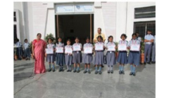 School kids are standing with school certificate