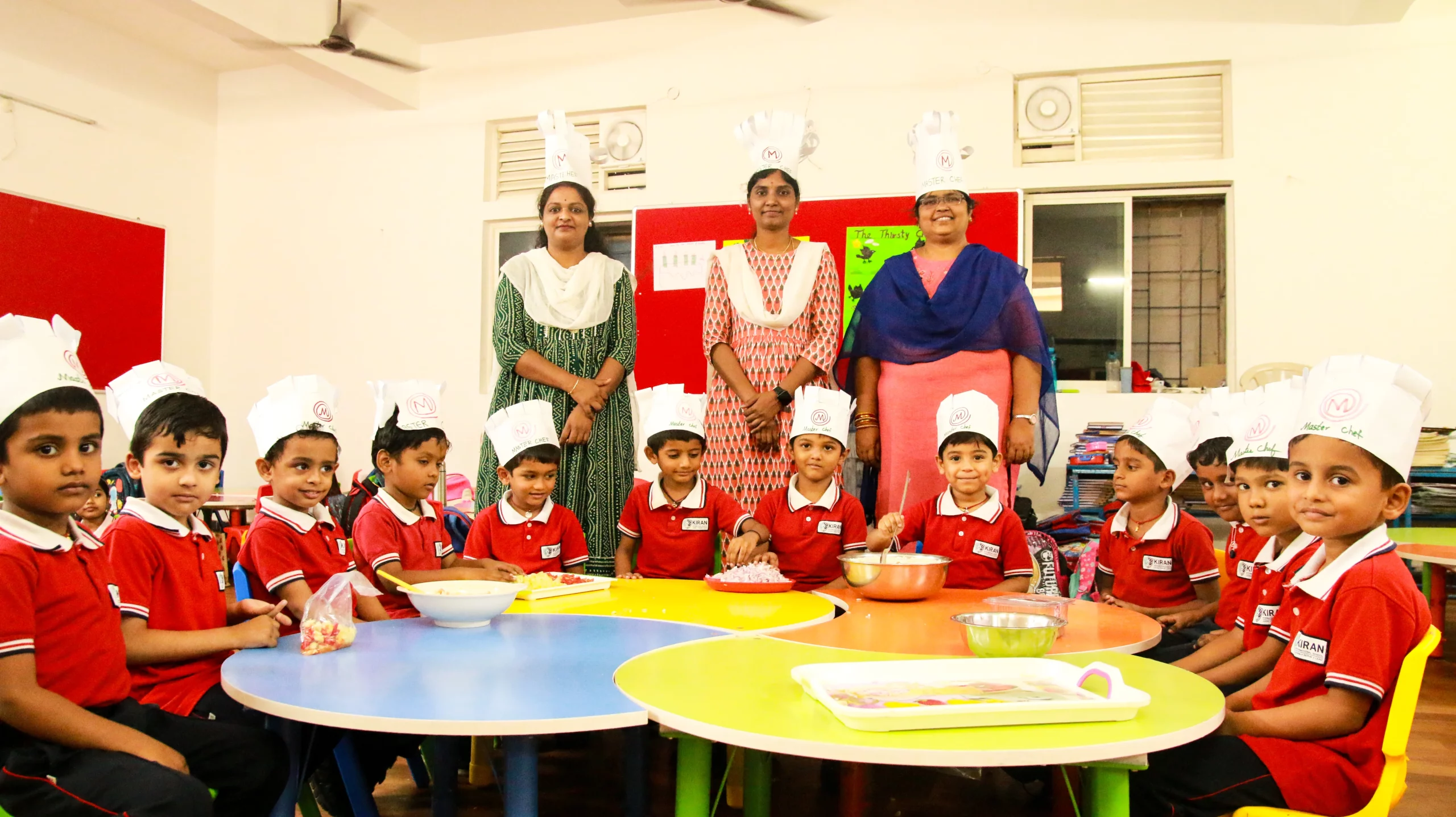 Young students engaged in a fireless cooking activity at Kiran International School's Pre-Primary section, learning culinary skills in a safe and supervised environment.