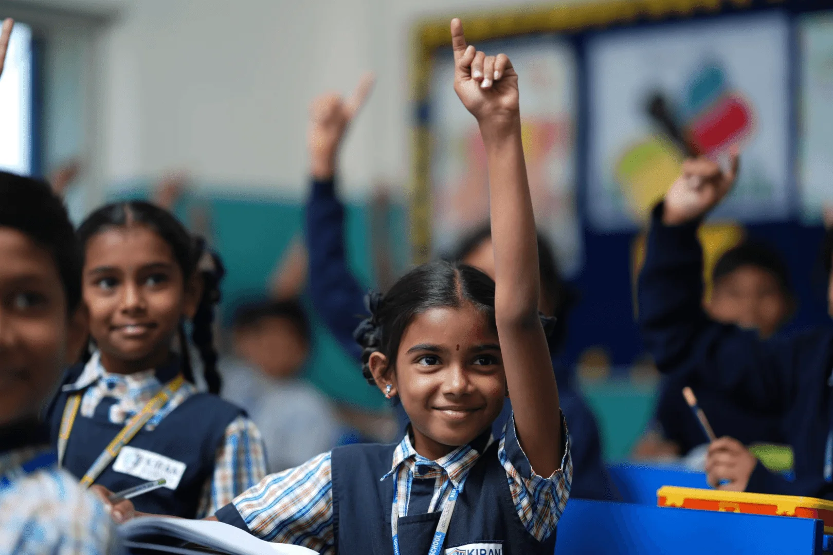 A joyful scene of students enthusiastically raising their hands, eager to answer the teacher's question and actively participating in the classroom discussion.