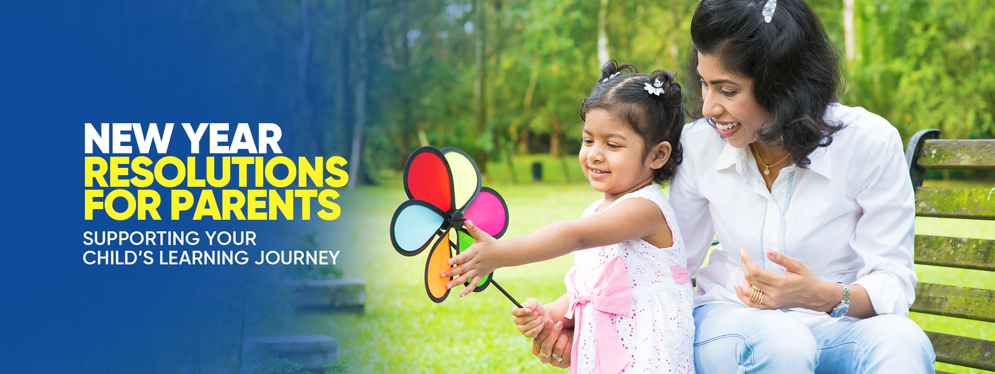 Mother and daughter in a park, engaging with a colorful pinwheel, emphasizing New Year resolutions for parents to support children's learning journey.